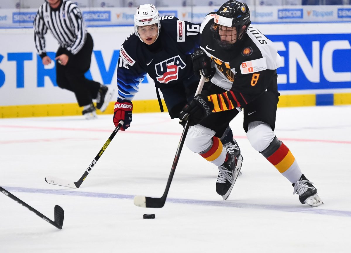OSTRAVA, CZECH REPUBLIC - DECEMBER 27: Germany's Tim Stutzle #8 skates with the puck while USAÕs Nicholas Robertson #16 chases him down during preliminary round action at the 2020 IIHF World Junior Championship at Ostravar Arena on December 27, 2019 in Ostrava, Czech Republic. (Photo by Andrea Cardin/HHOF-IIHF Images)